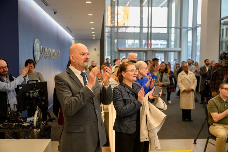 Officials applaud at the opening of the Cuyahoga County Financial Empowerment Center, where center residents can get free, one-on-one support to pay down debt, increase savings, and establish credit.